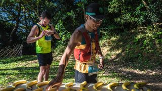 Chinese runner grabbing a banana at an aid station