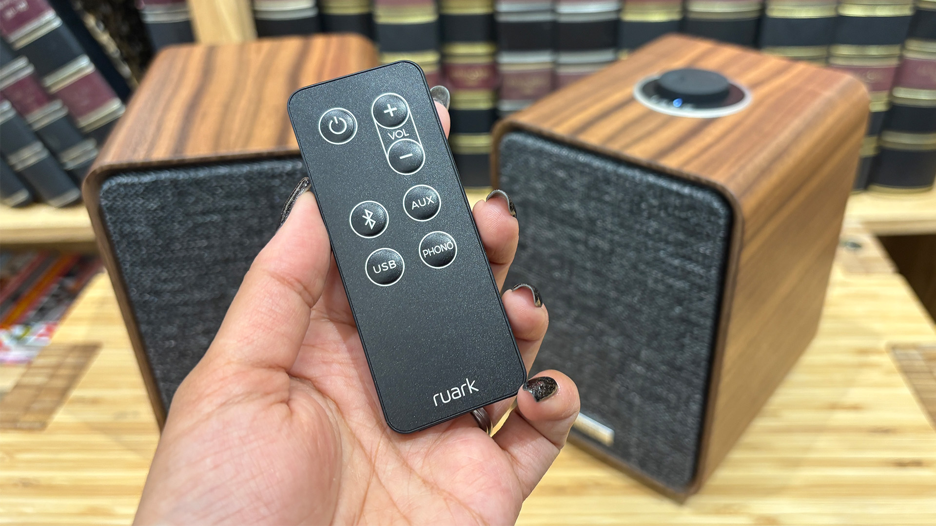 Ruark MR1 Mk3 active speakers with remote held in hand above
