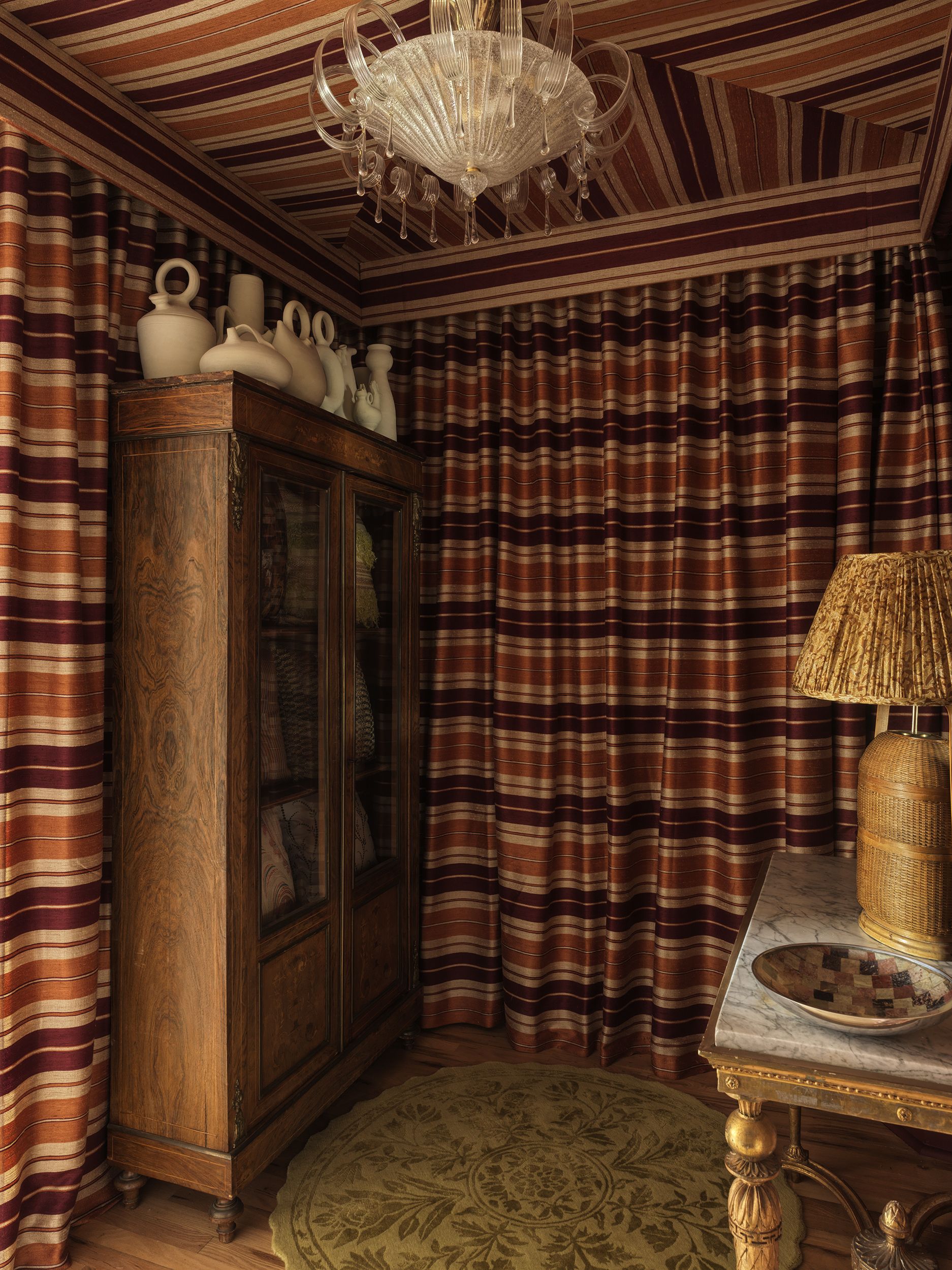 A showroom in Union Square with striped fabric draped across the walls and ceiling. 
