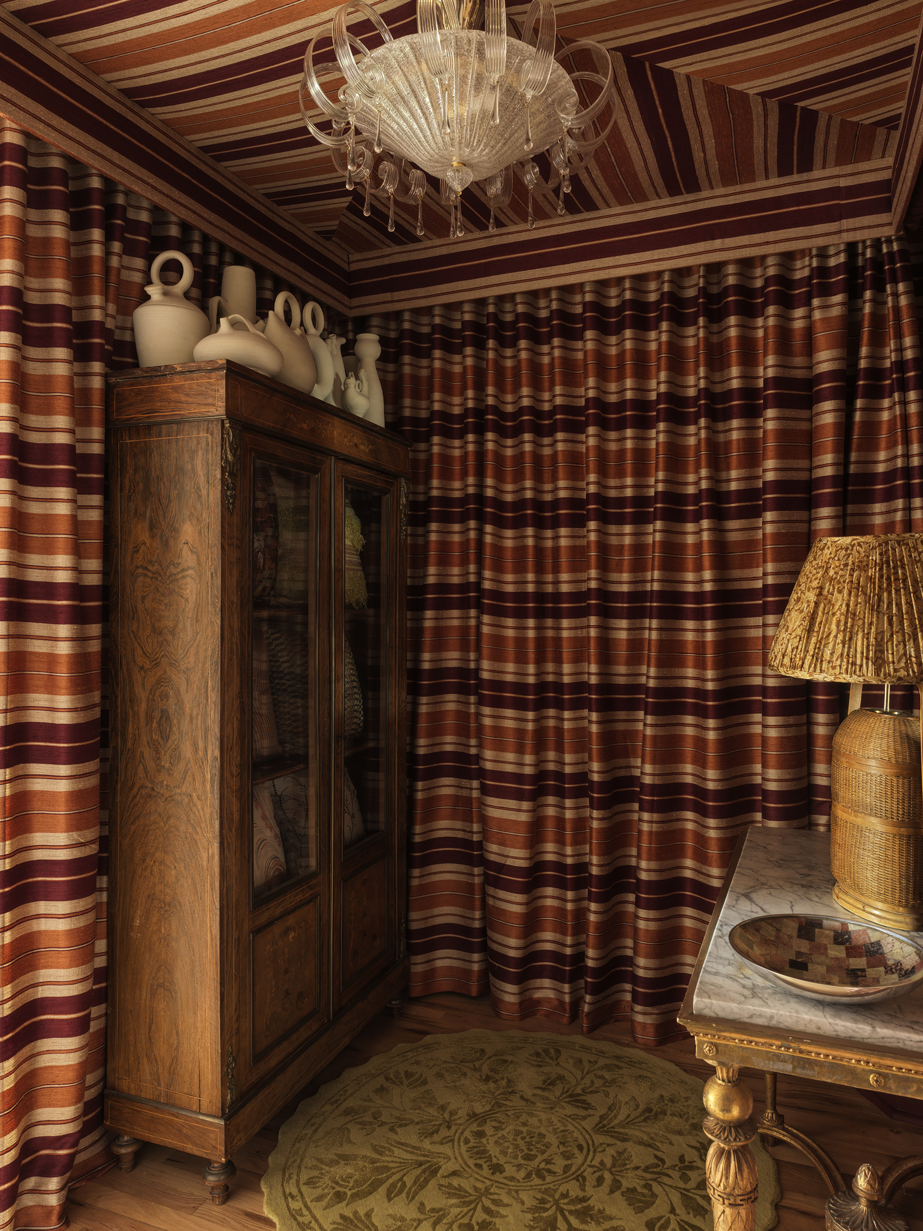 A showroom in Union Square with striped fabric draped across the walls and ceiling. 