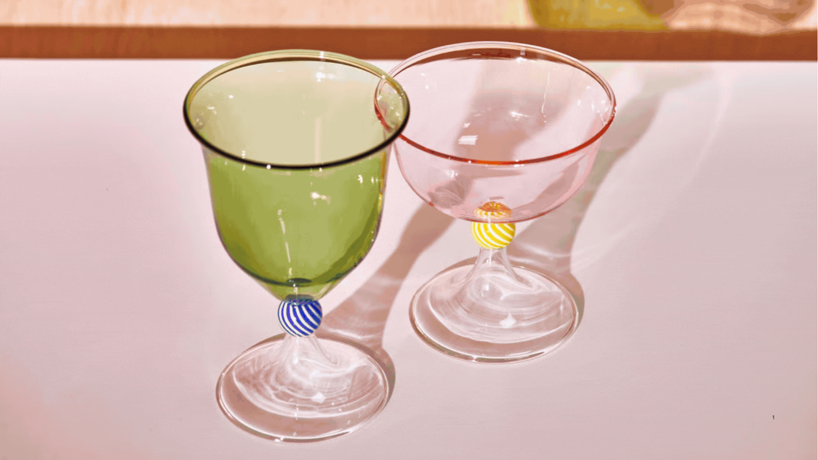 A rotating GIF of four images showing pastel glassware and dinnerware arranged on different table settings. 