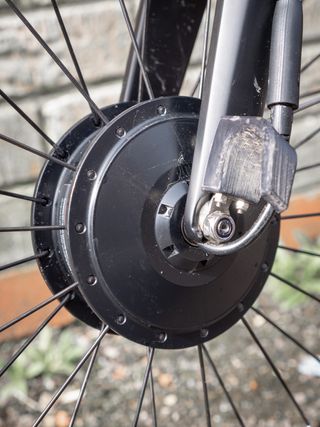 The black front-hub motor from Cytronex e-bike conversion kit, with a close up showing the wire entering from the non-drive-side