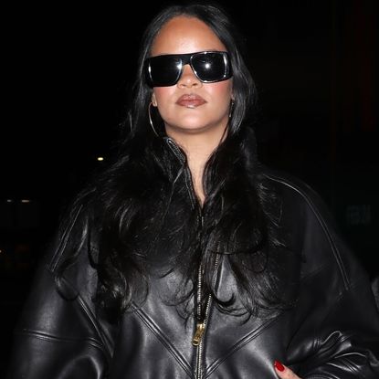 Rihanna and A$AP Rocky coordinated in black leather jackets, with RiRi in over-the-knee leather boots