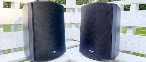 Klipsch AW-650 outdoor speakers positioned vertically on a deck