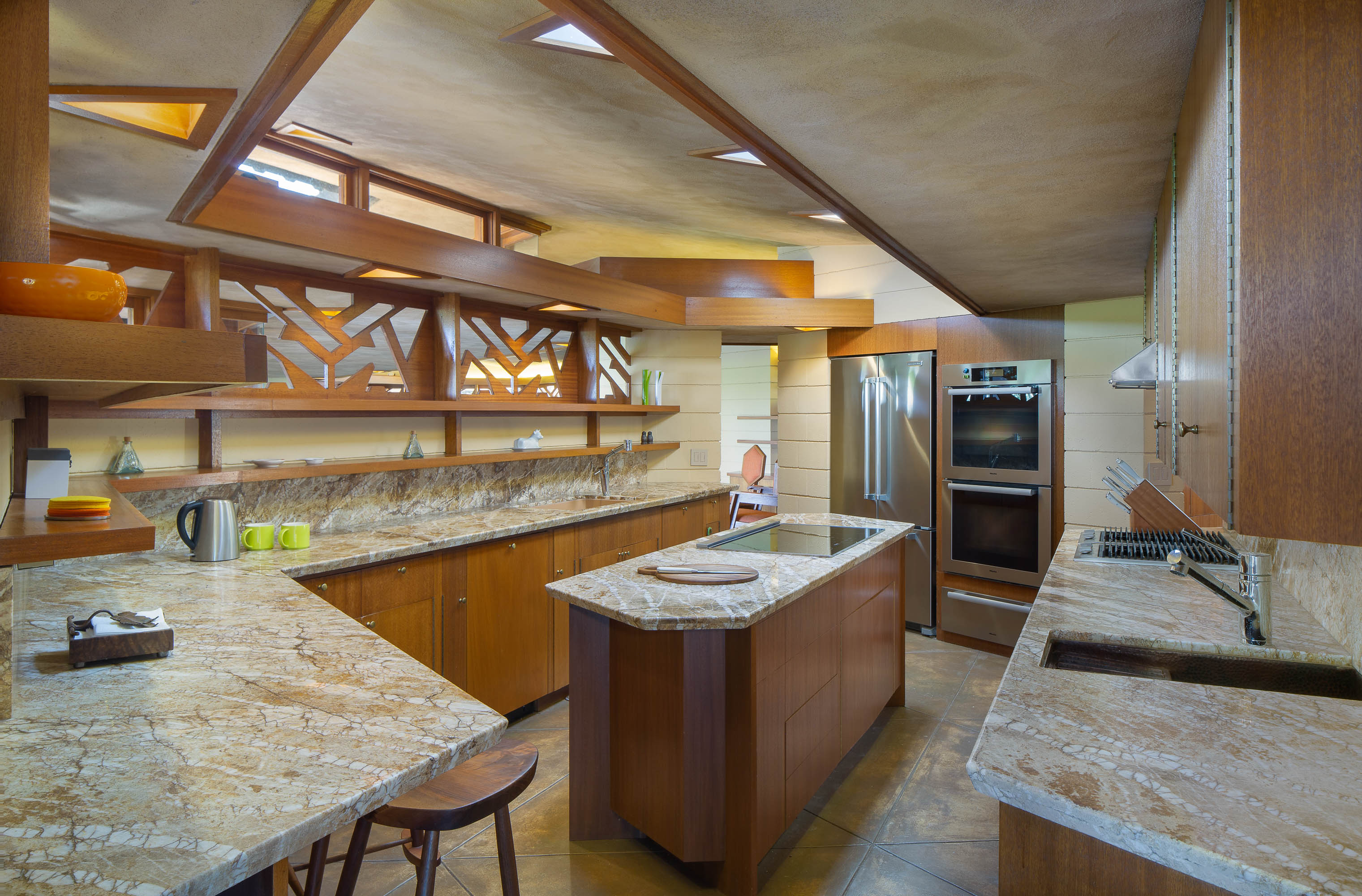 A kitchen with asymmetrical architecture and granite worktops