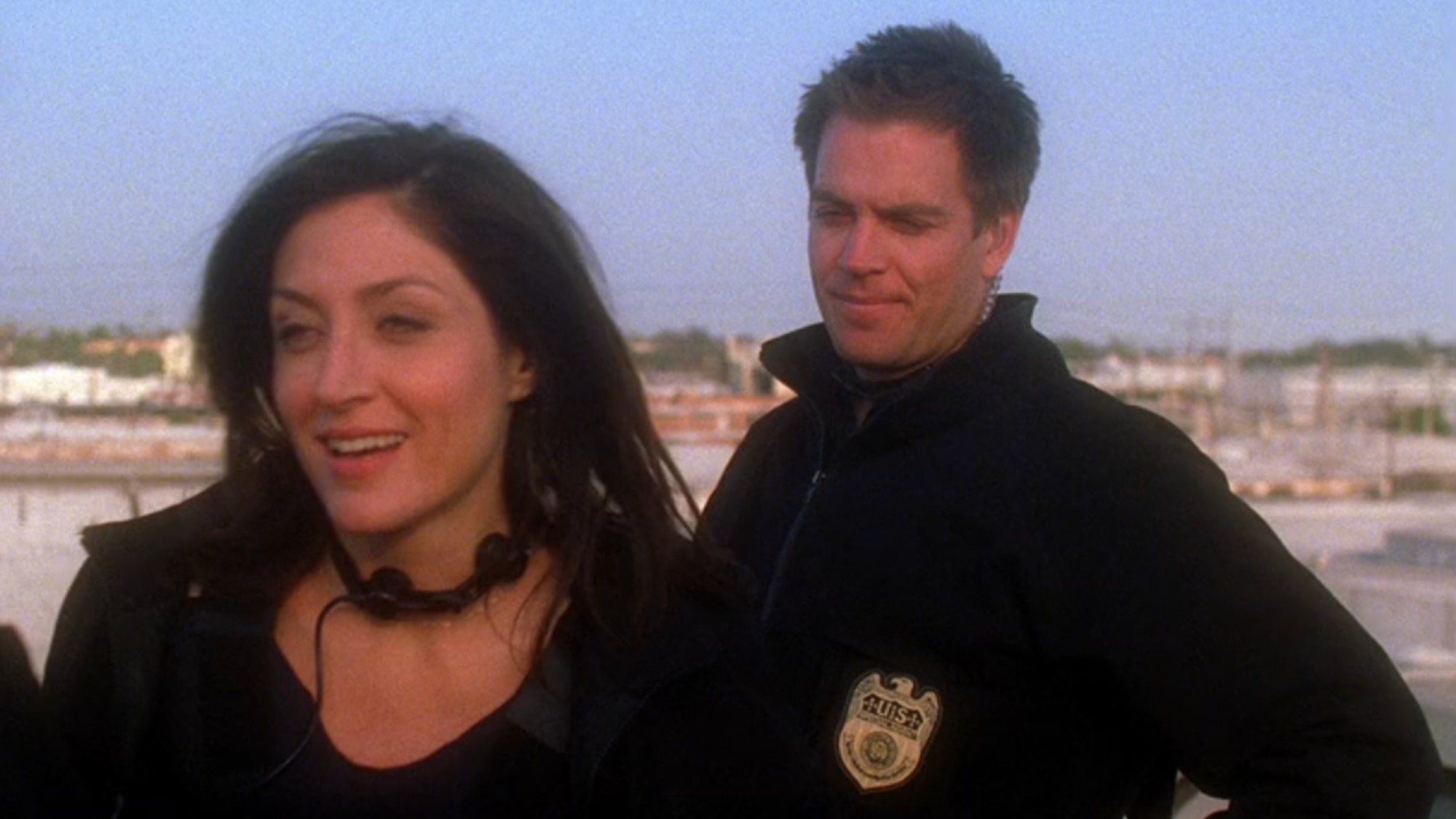 Tony standing behind Caitlin on a roof in the NCIS Season 2 finale.
