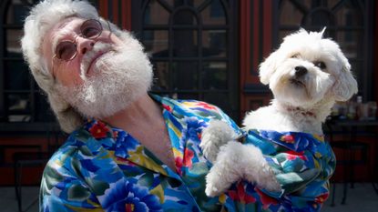 Senior man holding lookalike dog