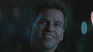 Val Kilmer looks up smiling during a night scene in Heat.