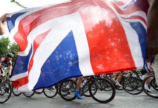 The peloton ride beneath a union jack flag
