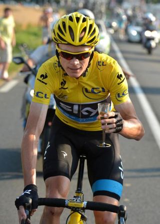 Time for a celebratory drink. Chris Froome (Sky) has a traditional glass of champage en route to Paris