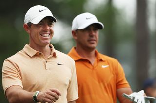 Rory McIlroy and Brooks Koepka walk during a Masters practice round