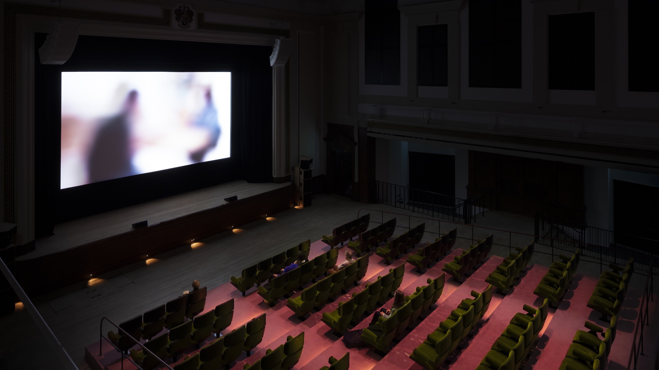 Prada Mode Elmgreen &amp;amp; Dragset installation which features hyper-realistic human figures sitting in a cinema
