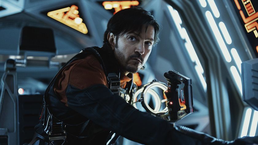 An intense man suited up inside a spaceship