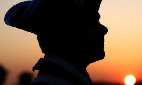 A Tea Partier stands in silhouette at the conclusion of Boston&amp;#039;s Tax Day rally.