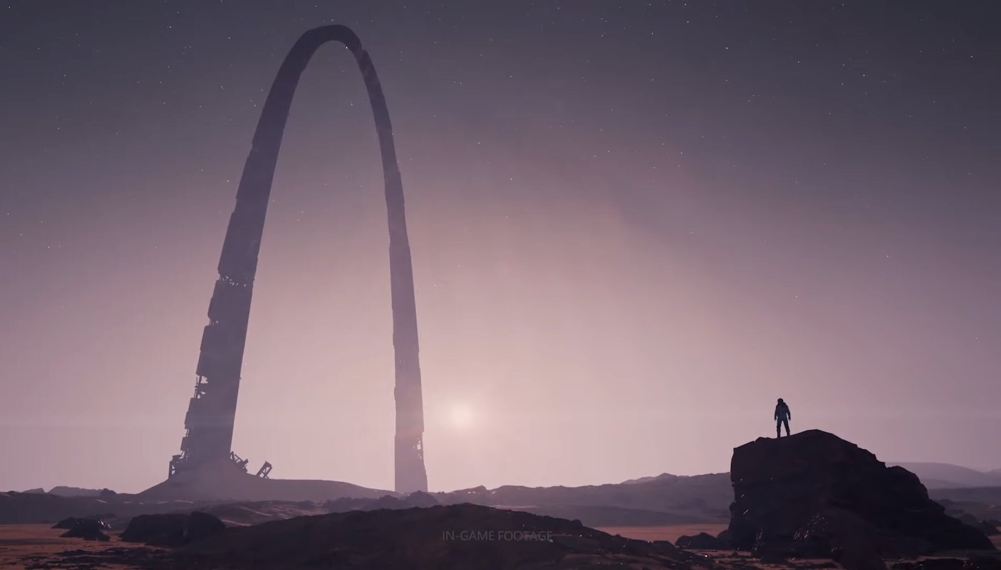 Something that looks like the St. Louis Gateway arch in the middle of a reddish desert