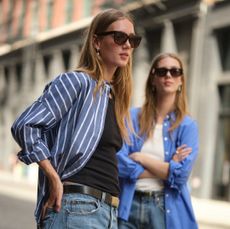 Two models wearing blue button-down shirts from Alex Mill