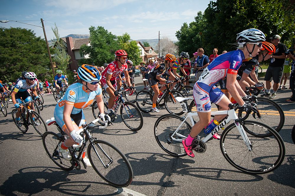 The field gets out of their saddle to add extra power to their pedal strokes up the climb.
