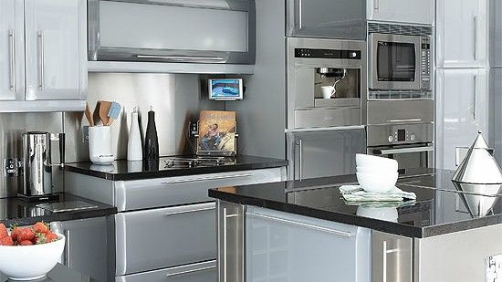 kitchen with sliver cabinets grey wall and black counter