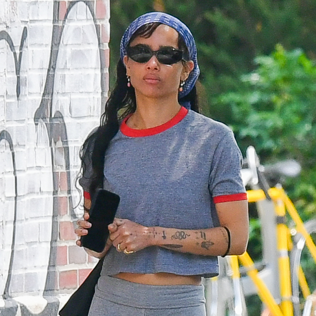 Zoë Kravitz coordinates her The Row flip flops to her ringer T-shirt.