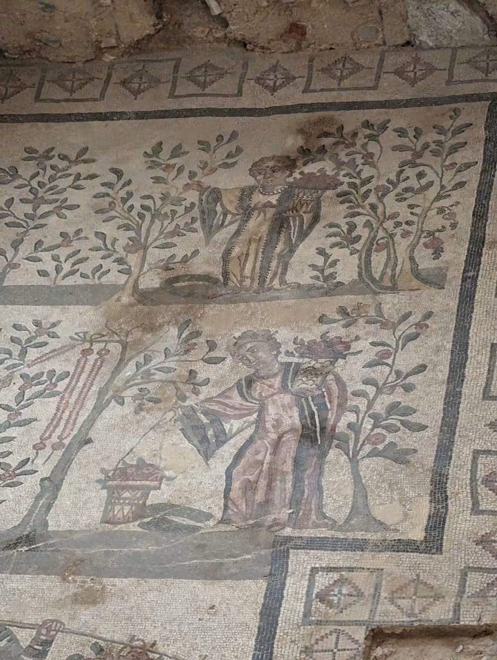 A close up of a mosaic of a woman in garden.