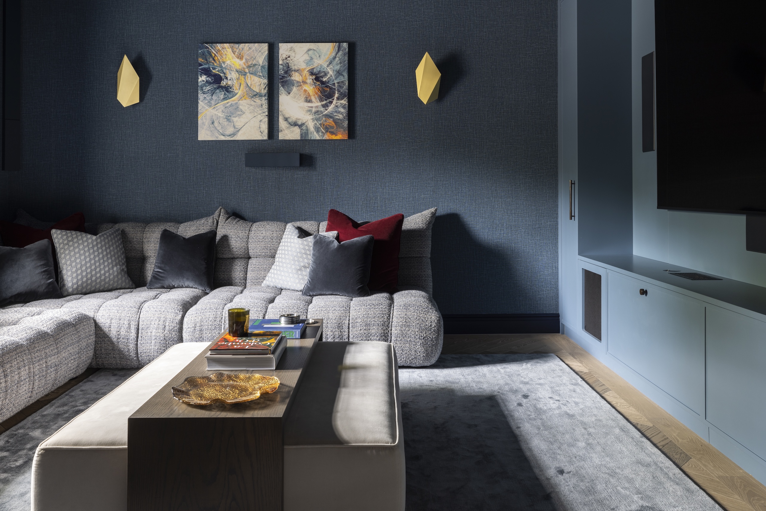 A grey modular sofa, without arms, in a contemporary living space