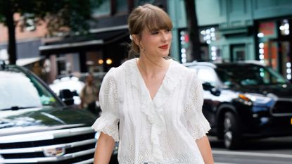 Taylor Swift in a white sheer top.