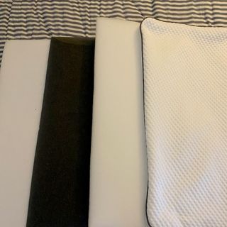 The foam inserts from the Emma Premium laid out on a bed with a striped grey and white duvet cover