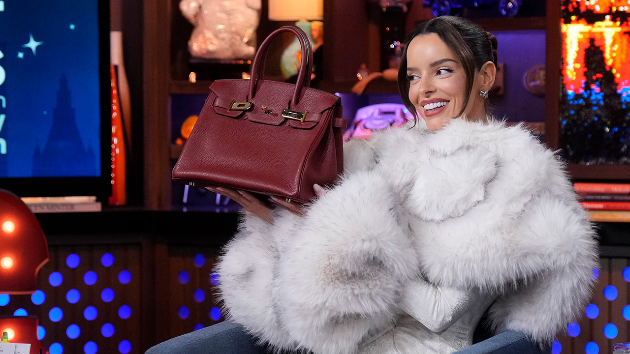 Maura Higgins holding her new Traitors loss Birkin on Watch What Happens Live