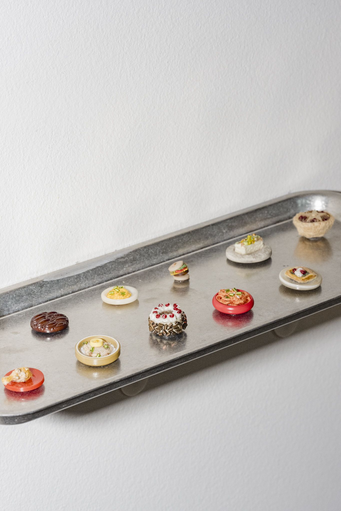 A silver platter covered in colorful treats.