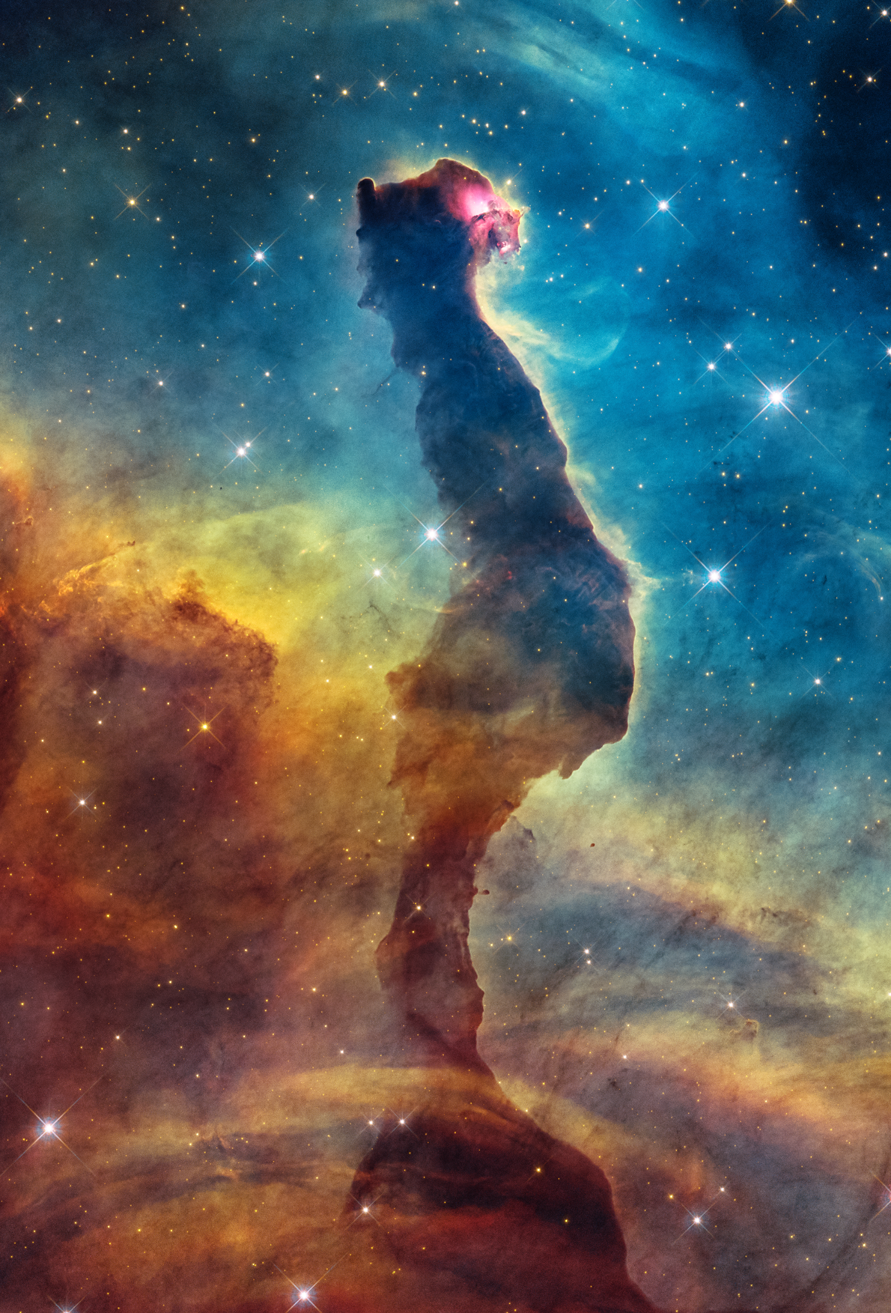 NASA&amp;rsquo;s Hubble Space Telescope shows an opaque dust pillar edged by a luminous rim of gas. Surrounding blue regions include emission from ionized gas and scattered starlight. The cat&amp;rsquo;s glowing red eye may indicate a young star embedded in the dust