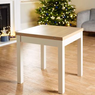 room with wooden dining table and christmas tree