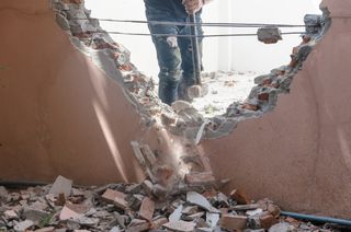 a person knocking down a wall in their home