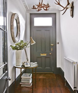 hallway with white wall and lamp on table