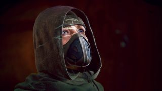 Dune: Awakening fast travel - A close-up of a character dressed in Fremen attire, looking upwards slightly.