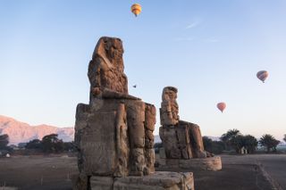 Hot air balloons over the Colossi of Memnon in Egypt