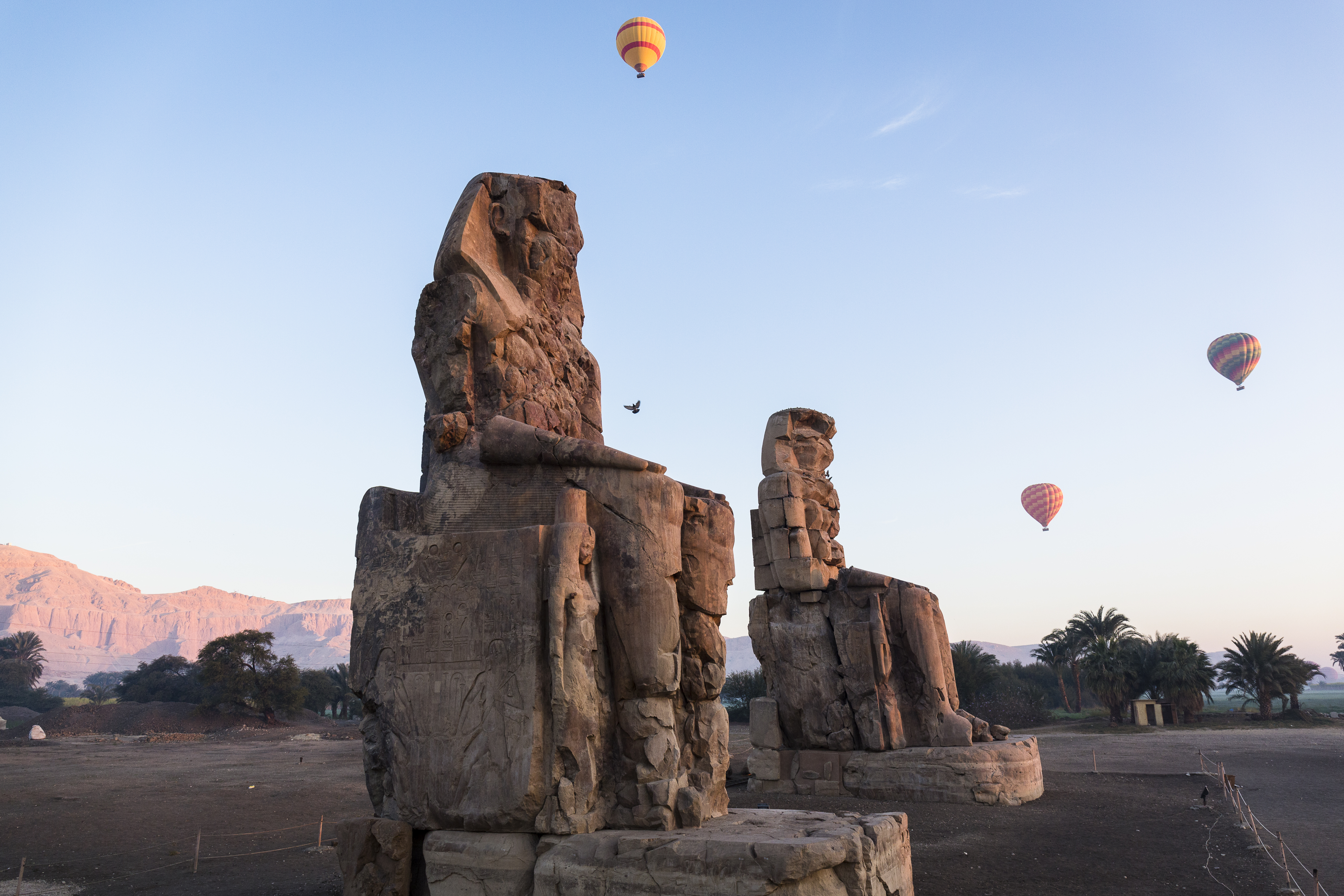 Hot air balloons over the Colossi of Memnon in Egypt