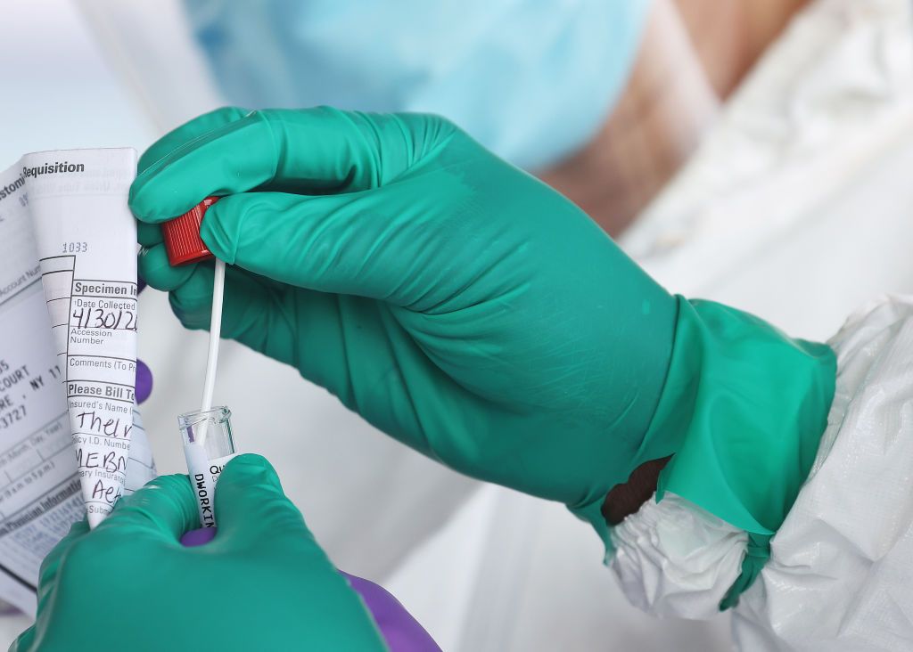 A Health Care Worker seals a coronavirus swab after testing at the Pro Health Urgent Care coronavirus testing site on April 30, 2020 in Wantagh, New York.