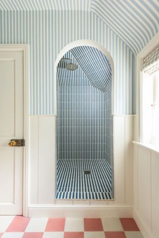 stripy shower room with pink checked floors