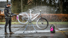 Man cleaning bike with Muc-Off product