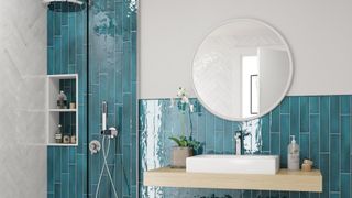 white bathroom with turquoise tiles creating zones for sink and shower areas