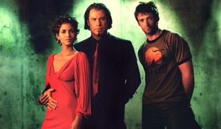 Halle Berry, John Travolta, and Hugh Jackman stand together in Swordfish.