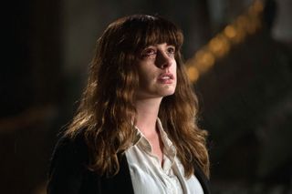 Anne Hathaway crying and looking up at the sky in 'Colossal'