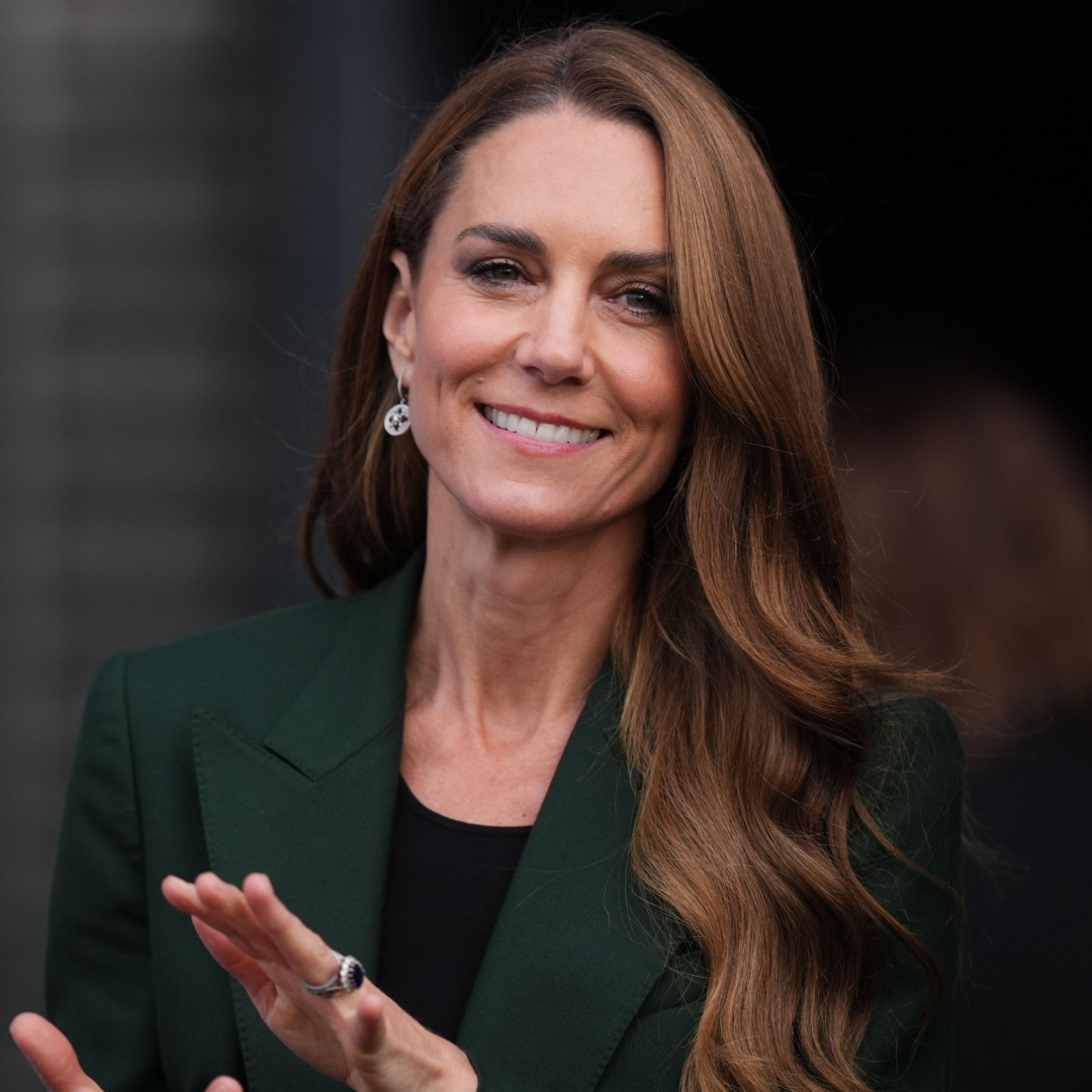 Princess Kate wearing a green blazer and clapping