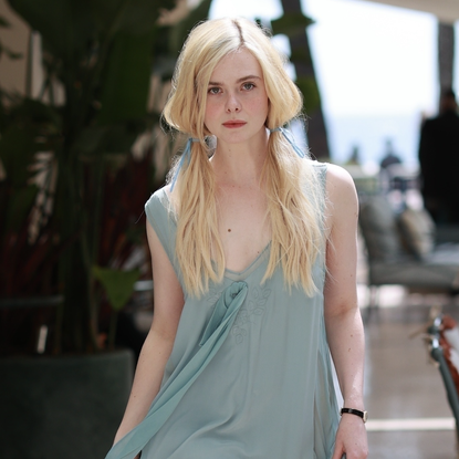 Elle Fanning getting ready to head out to a premiere in Cannes in a blue dress