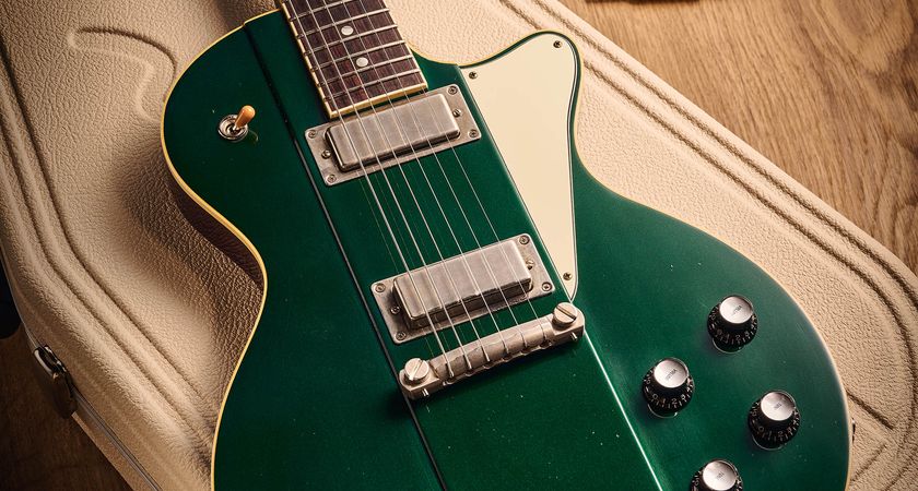 Ivison Dakota Standard in Cadillac Green photographed against its cream-covered Hiscox hard-shell guitar case.