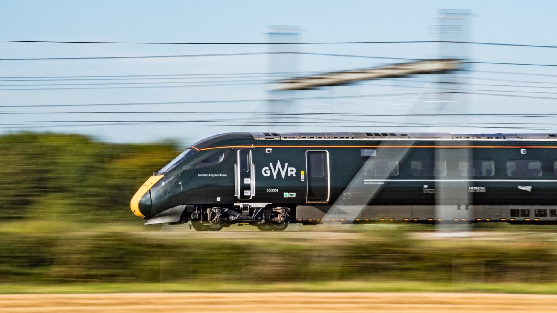 A GWR train driving on a railway track.