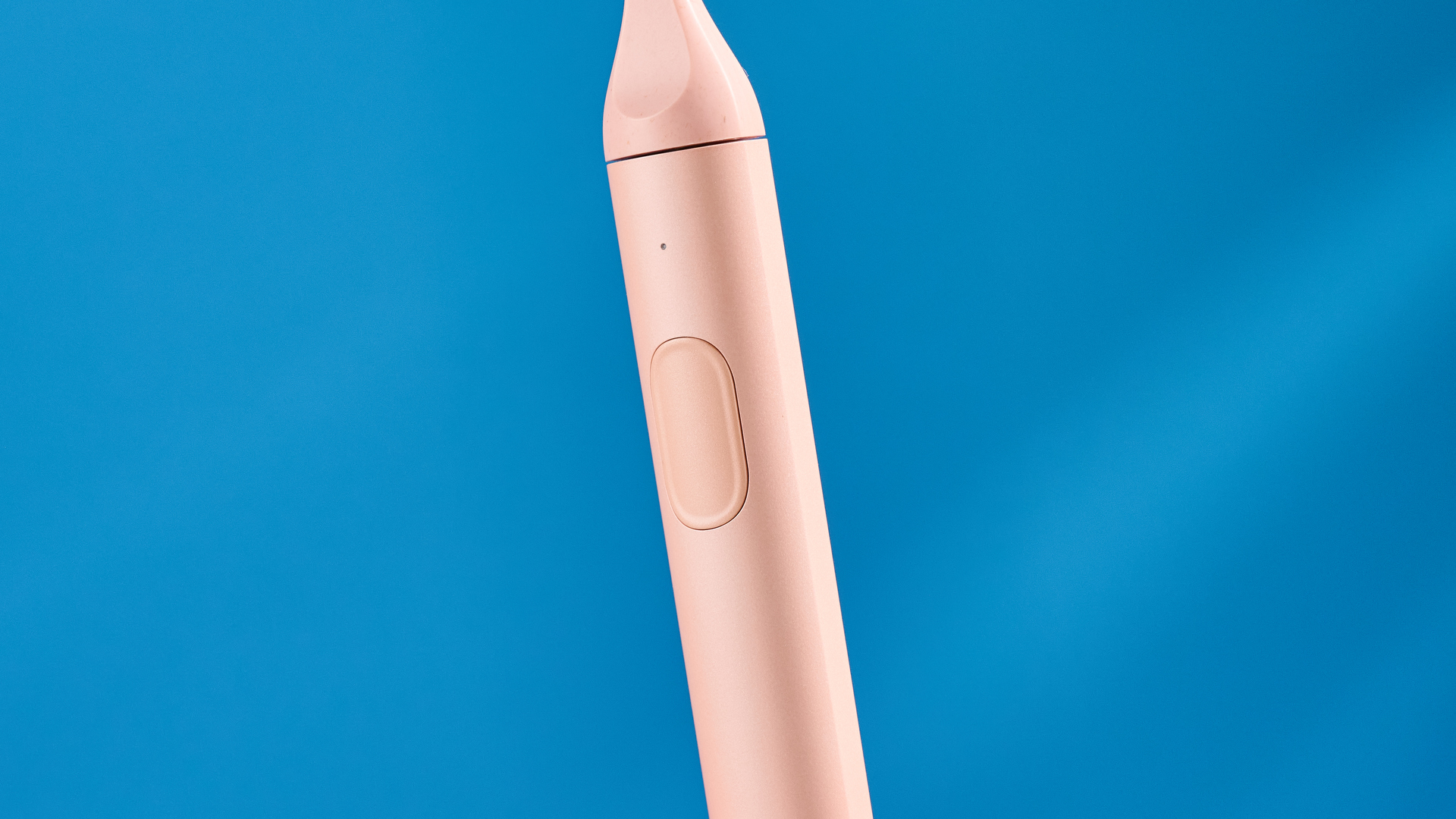 the Suri 2.0 toothbrush in sunset bloom pink colorway with a plant-based head and aluminum body, pictured with its uv cleaning travel case and the suri toothpaste