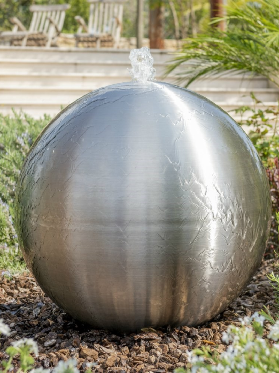 A spherical brushed stainless steel water feature from Primrose
