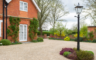 Gravel driveway with lamp in middle