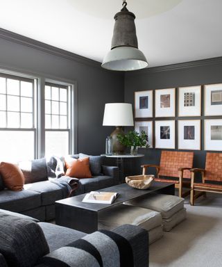 A gray living room with brown accents and a gallery wall